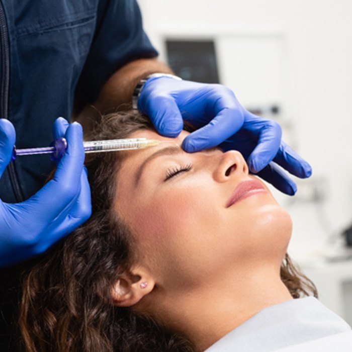 a cosmetic dentist administering BOTOX