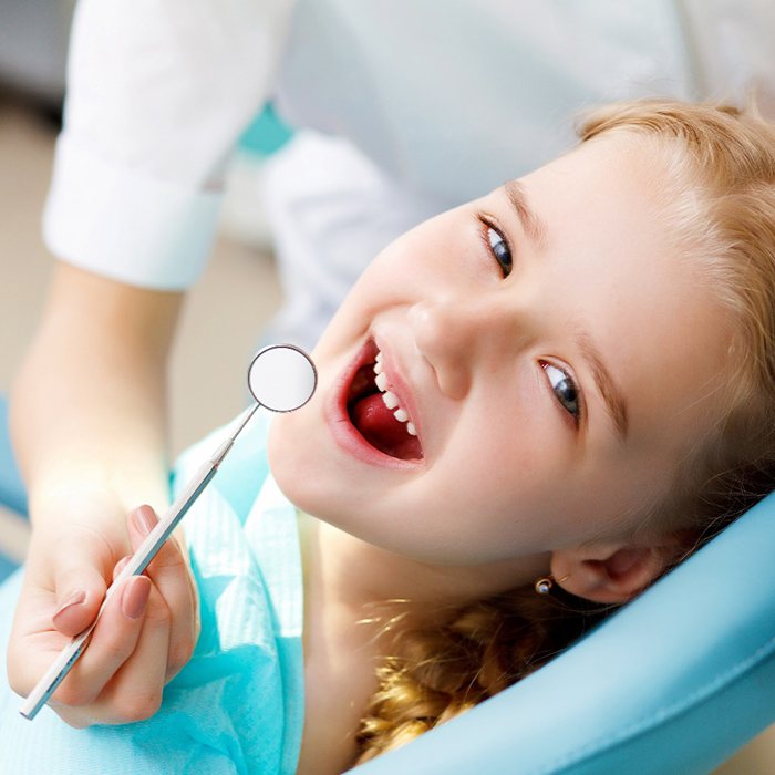 Cute little girl getting dental crowns in Inver Grove Heights