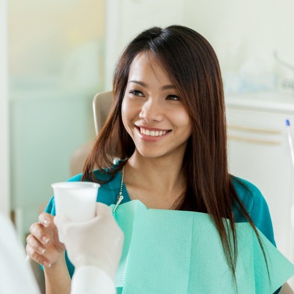 Woman smiling while receiving dental services in Waldorf Maryland