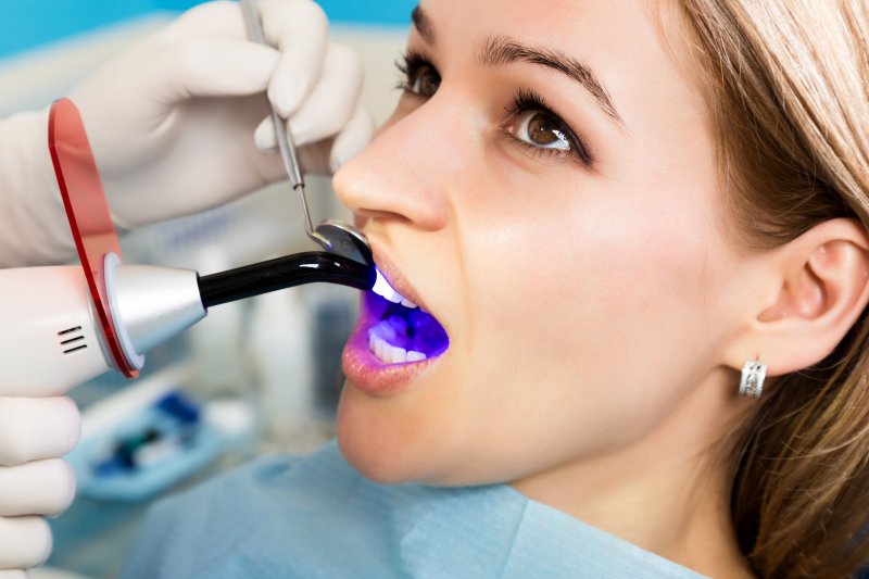 A woman having a dental bonding treatment